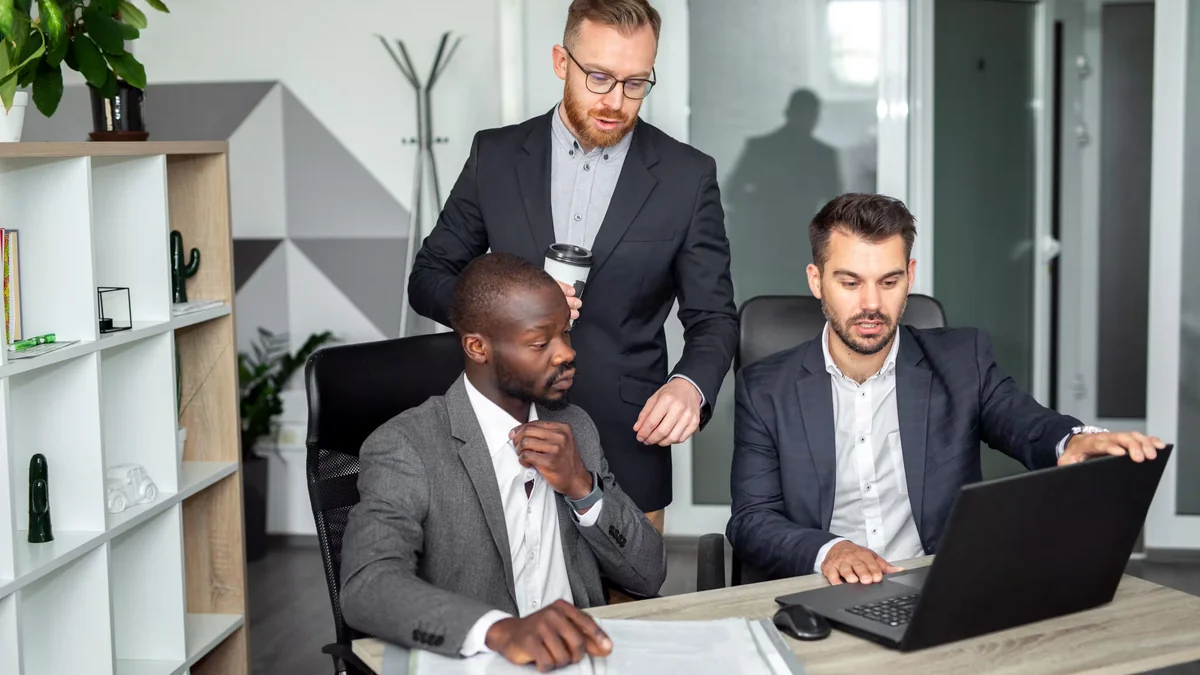 Business manager presenting operational metrics and data charts on a screen