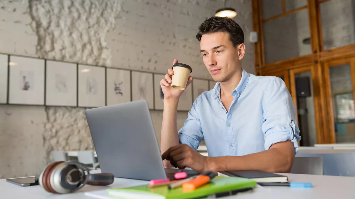 University graduate preparing their first entry level CV on a laptop