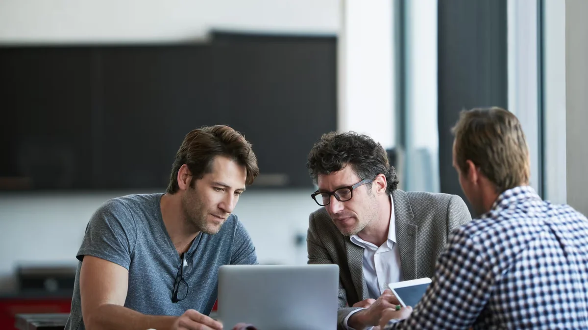 Professional optimizing a digital career profile on a computer workstation